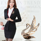 Swan crystal brooch worn on a black blazer lapel, rose-gold tone with clear stones