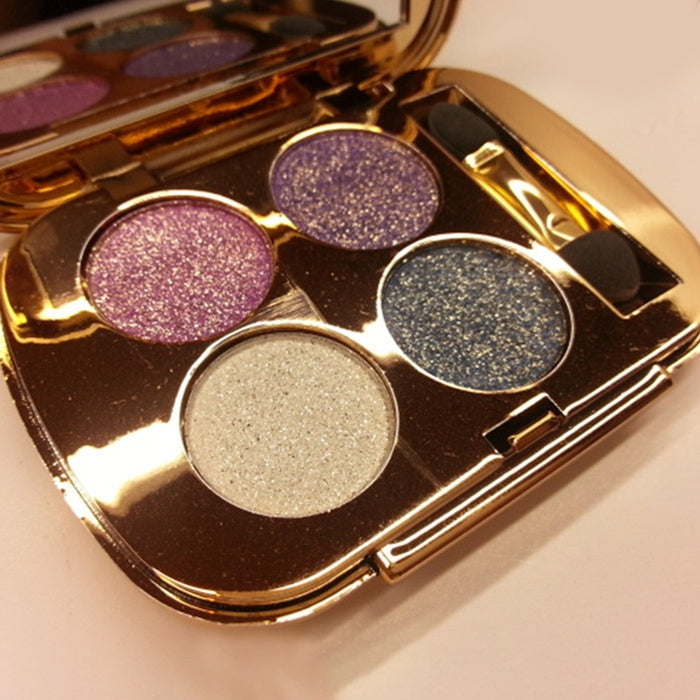 Gold eyeshadow palette with five round glitter pans: pink, purple, beige, blue, charcoal