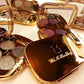 Open gold glitter eyeshadow palette with mirror, showing pink, purple, and gold-toned pans