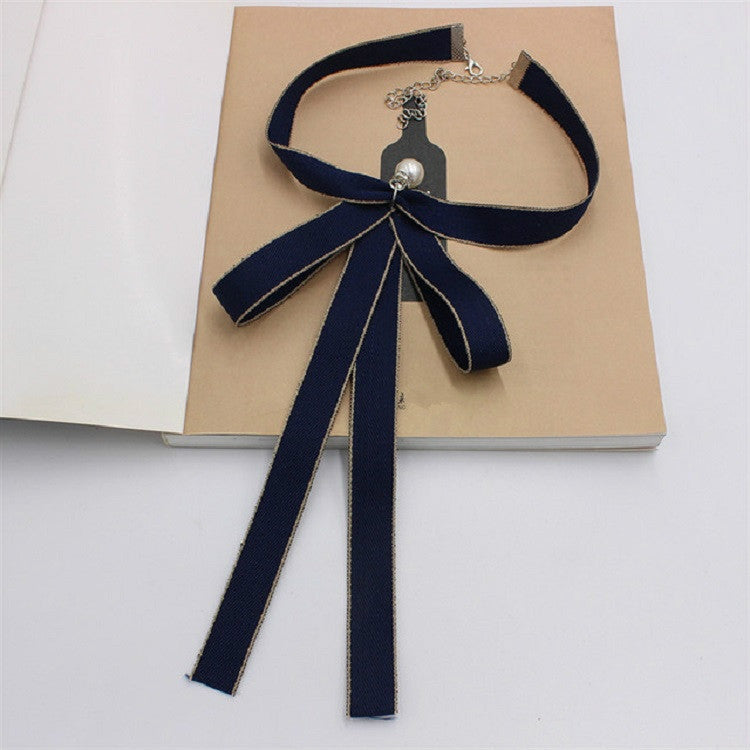 Women’s dark blue ribbon bow tie with pearl center and silver-tone chain