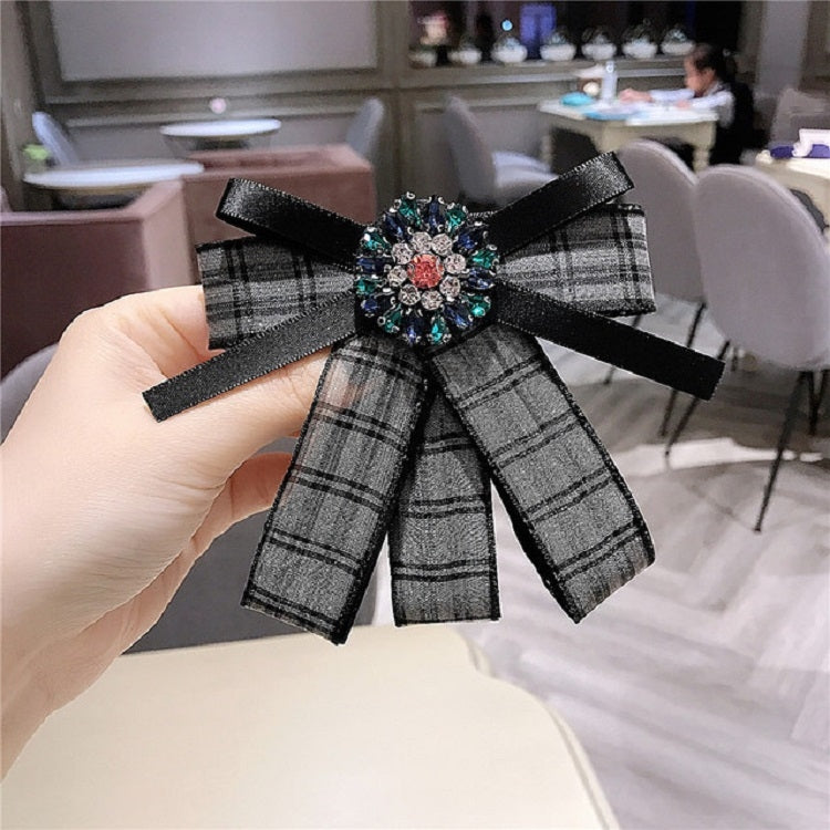 Black plaid bow brooch with jeweled diamond centerpiece and black ribbon streamers