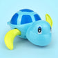 Light blue turtle water play toy with green fin and side view