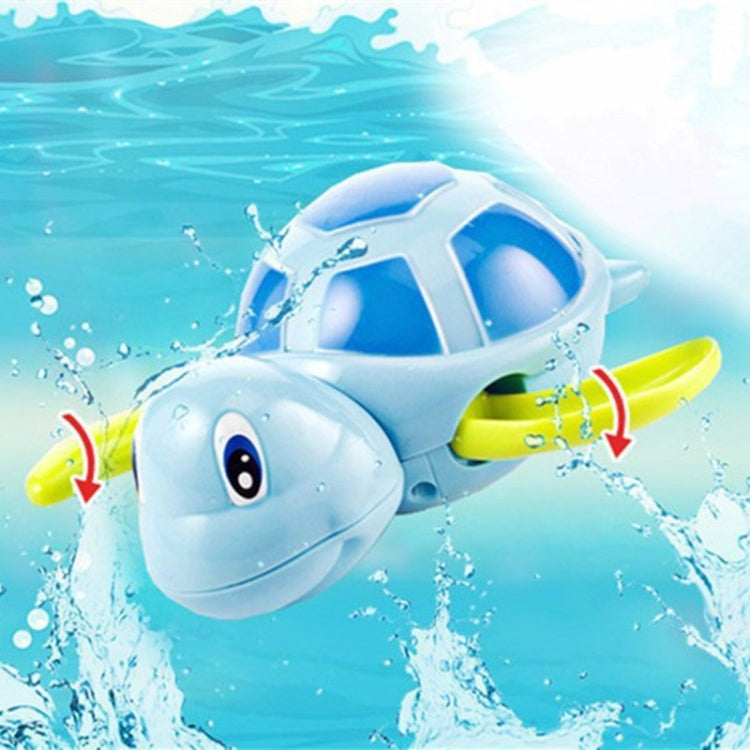 Blue and green turtle water toy splashing in pool water