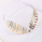 Gold leaf crystal headband with layered leaf details and a central sparkling gem