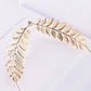 Gold leaf metal headband with ornate branch design and rhinestone accents