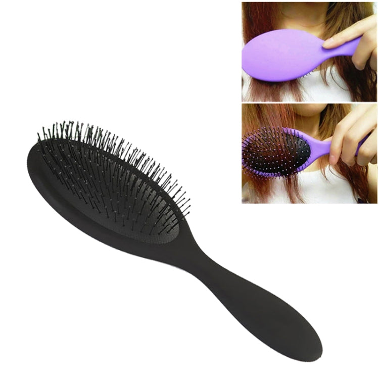 Black hair brush with oval black bristle pad and long handle
