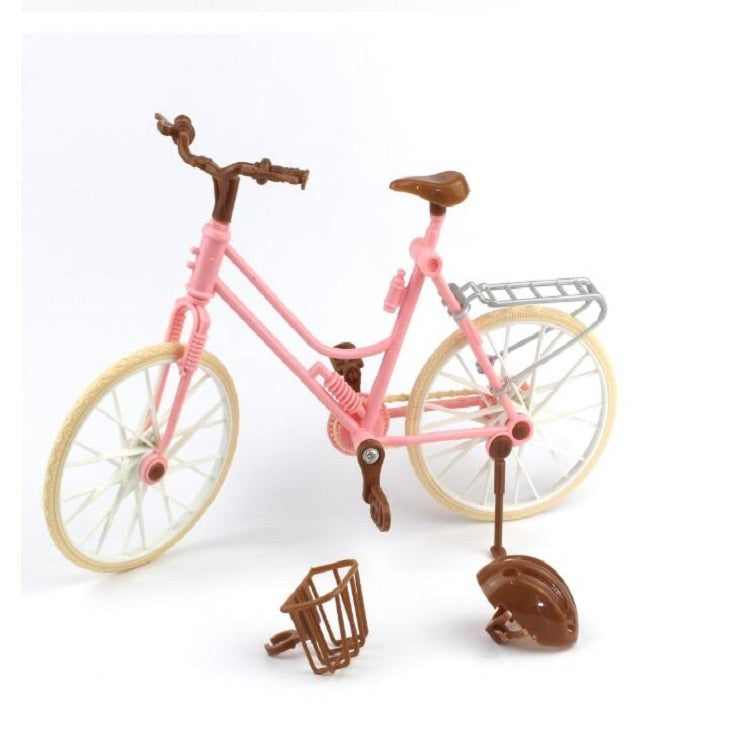 Mini dollhouse bicycle with pink frame and tan wheels, plus loose brown front parts