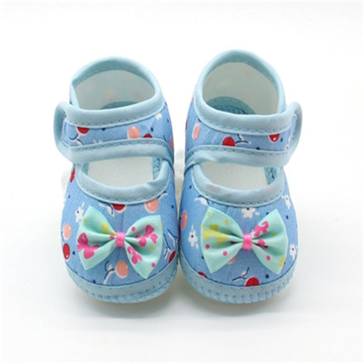 Blue baby prewalker shoes with bow and playful fruit-pattern design, soft sole
