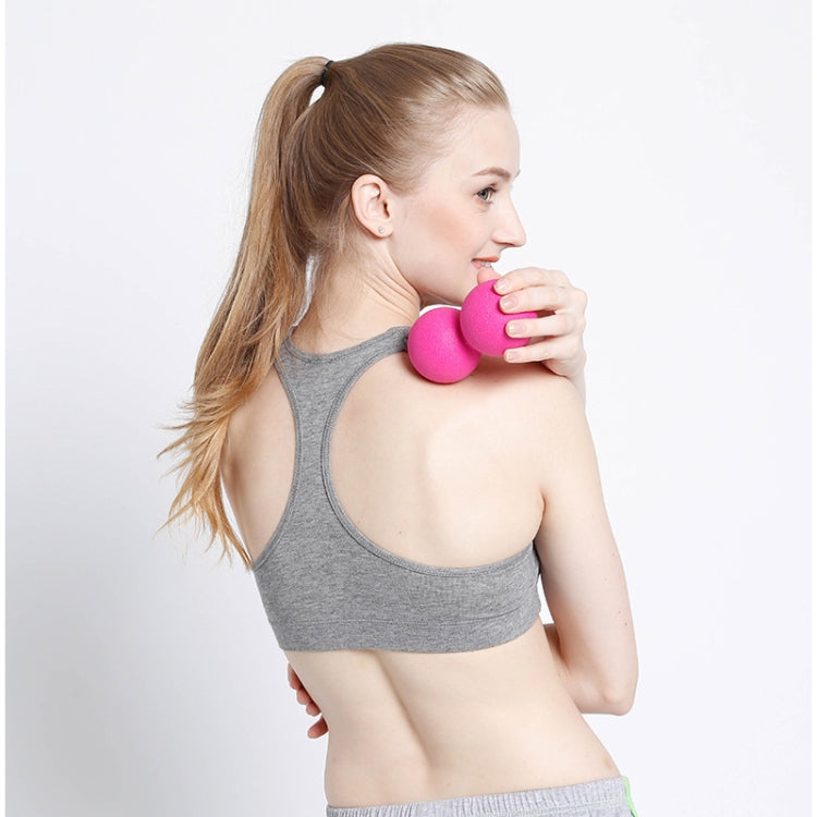 Pink silicone massage ball held in hand for fitness and self-massage