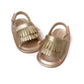 Gold-toned fringed baby sandals with hook-and-loop ankle straps, top view