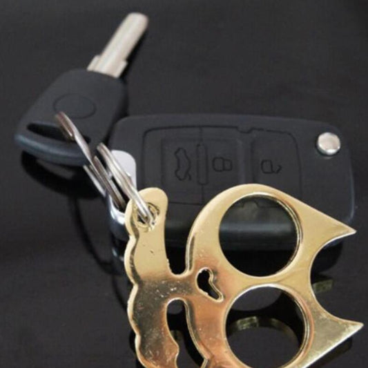 Gold cat-shaped metal keychain self-defense tool close-up with keyring loop