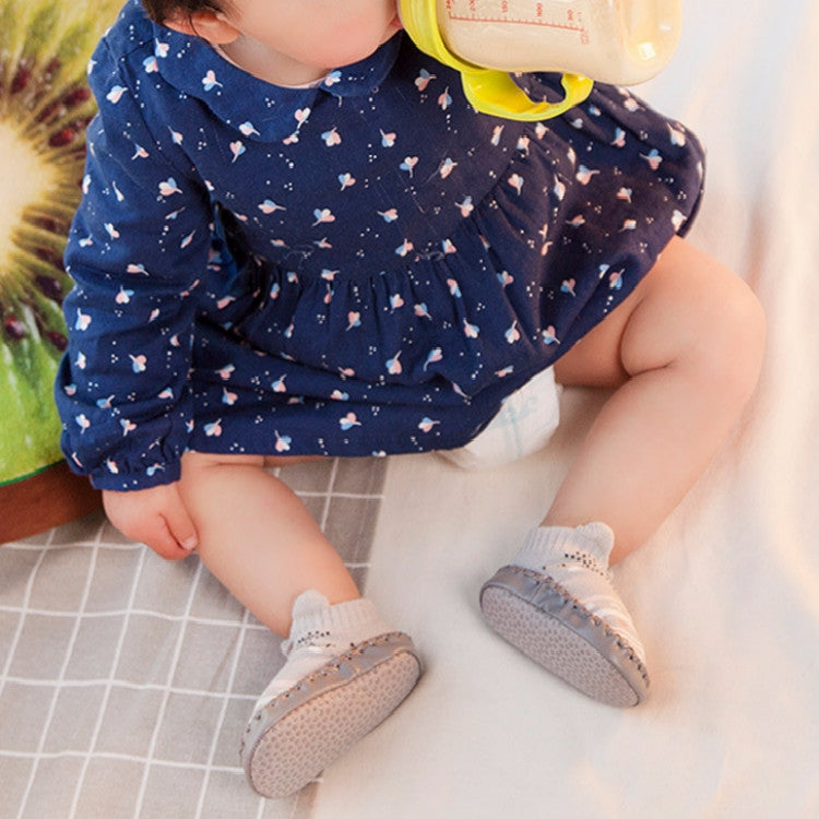 Gray toddler non-slip socks with textured grip soles on a child’s feet