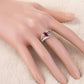 Sterling silver finger ring with red teardrop zircon on a hand