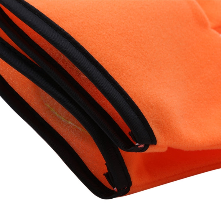 Close-up of orange plush glove edge with black stitched border and textured fabric.