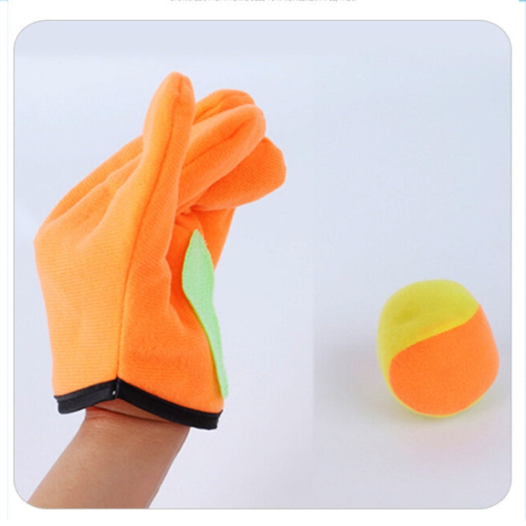 Child hands wearing orange plush catching glove with green pad, plus orange sticky ball.