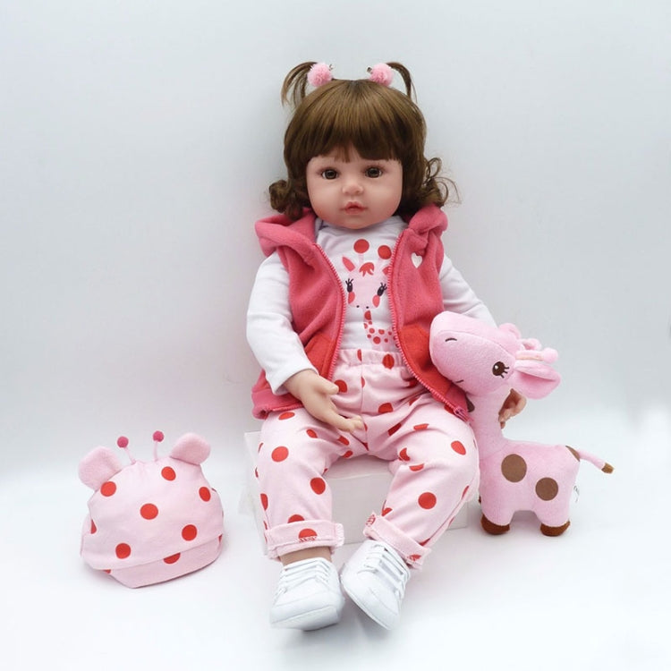 Baby girl silicone doll in pink sleeveless hoodie over white animal-print outfit, with pink plush toy
