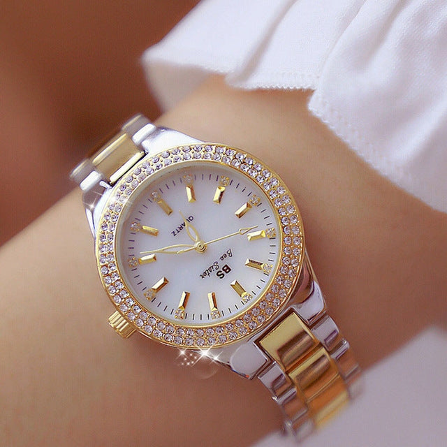 Women’s round watch with white dial, jeweled bezel, and two-tone metal link strap