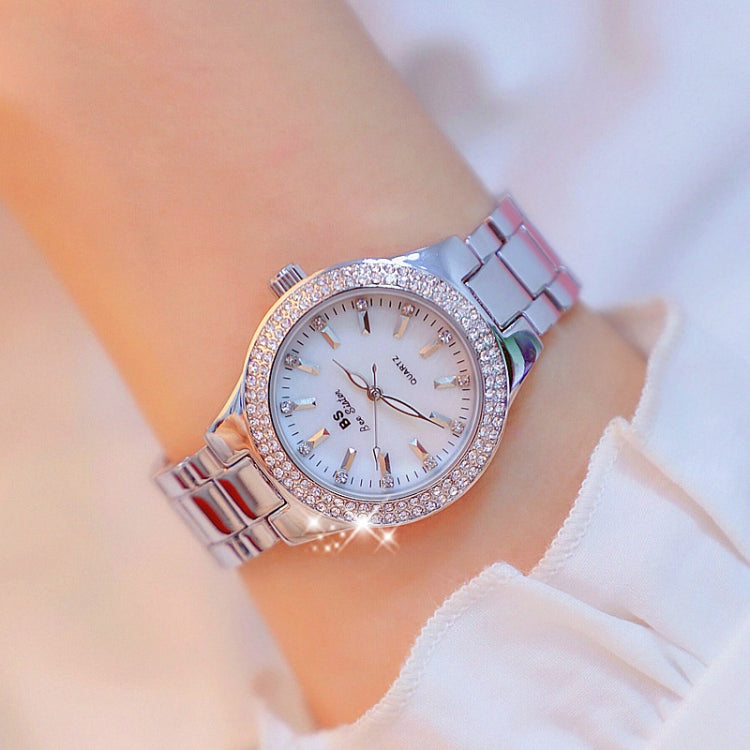 Women’s silver-tone round watch with white dial, rhinestone bezel, and metal link strap