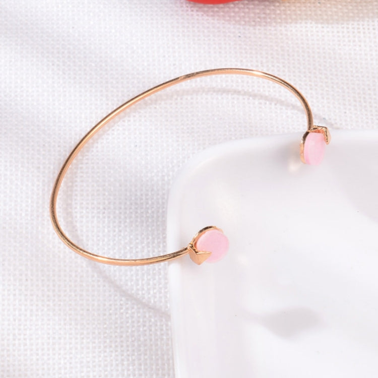 Rose-gold open cuff bracelet with pink heart charms on both ends