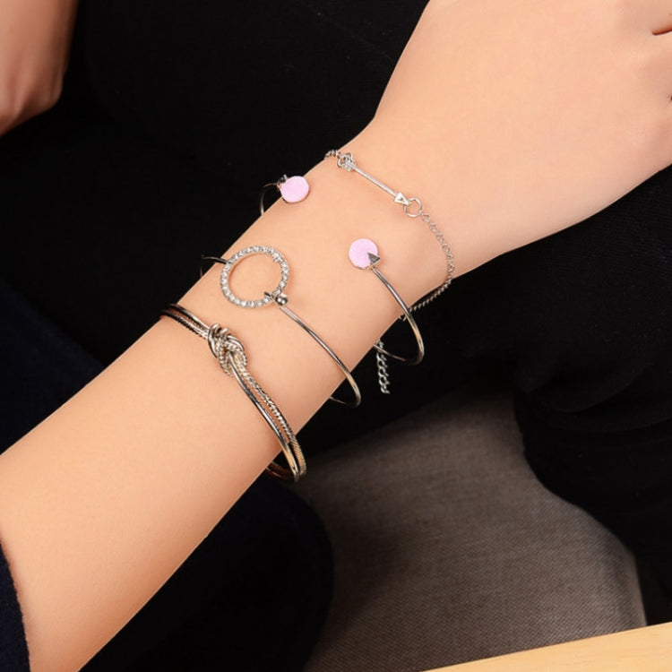 Silver-tone multilayer bracelet set on wrist with pink heart charms and crystal hoop