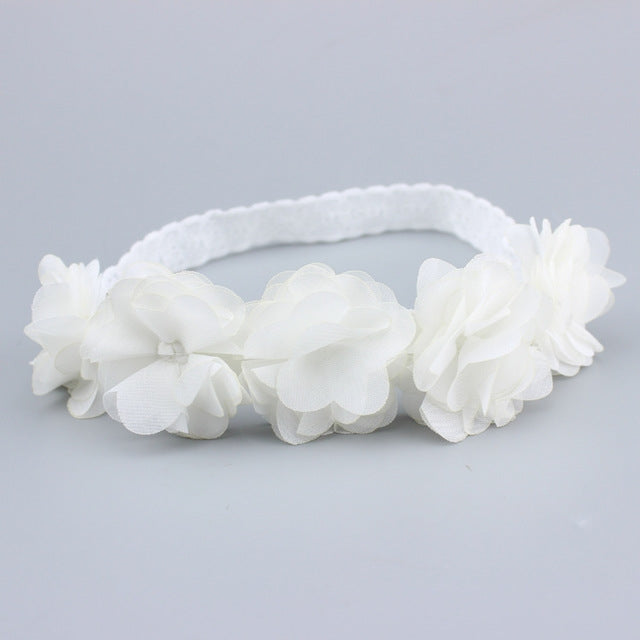 White baby flower headband with layered fabric rosette flowers and soft elastic band