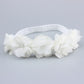 White baby flower headband with three large rosette blooms and soft elastic band