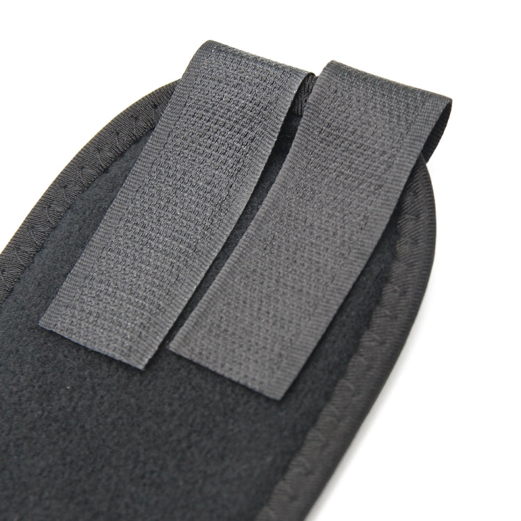 Gray cushioned toe separator pads with fabric straps, close-up view