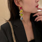 Gold-tone oval gemstone drop earrings in red, yellow, green, and blue-purple