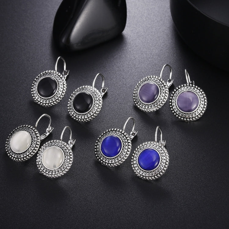 Assorted round drop earrings with ornate silver frames in black, white, purple, blue