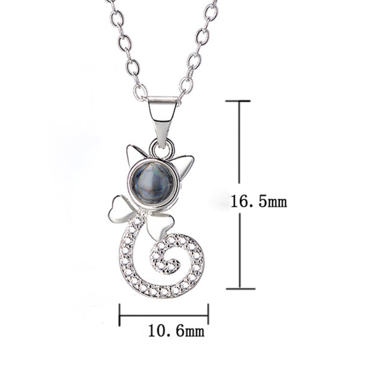 White metal projection pendant necklace with round blue disc and heart swirl charm, crystal accents