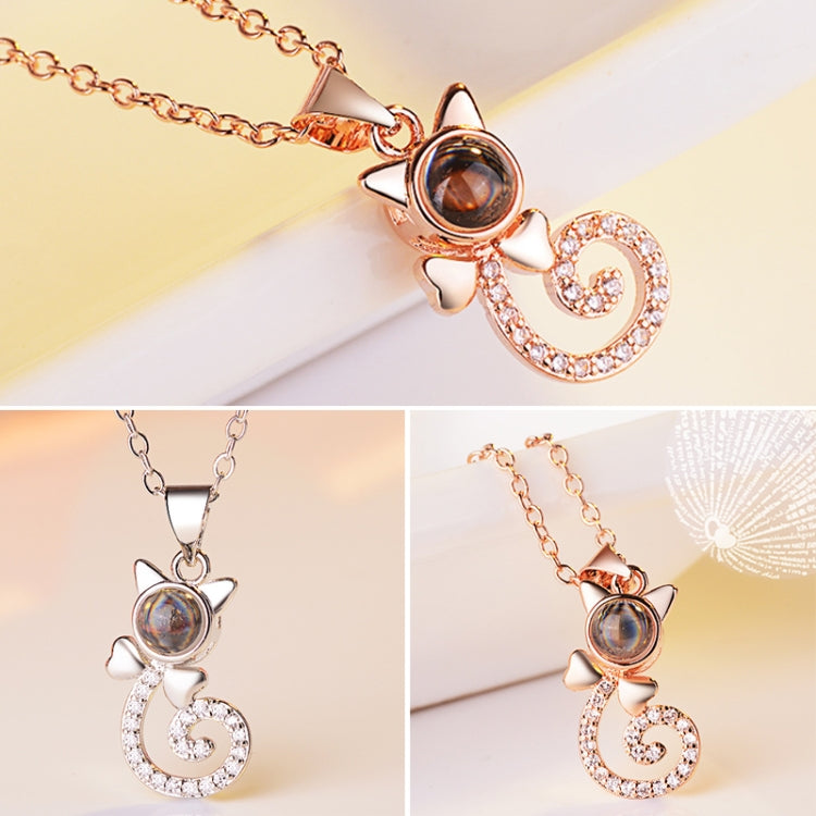 Rose gold projection pendant necklace with round dark disc and heart swirl charm, crystal stones