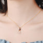 Rose gold projection pendant necklace with small round disc and heart swirl charm, crystal accents