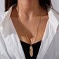 Gold long feather pendant necklace with leaf-textured feather charm