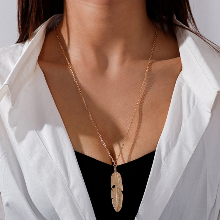 Gold long feather pendant necklace with leaf-textured feather charm