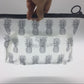 Transparent PVC cosmetic bag with gray pineapple print, top black zipper, wrist loop