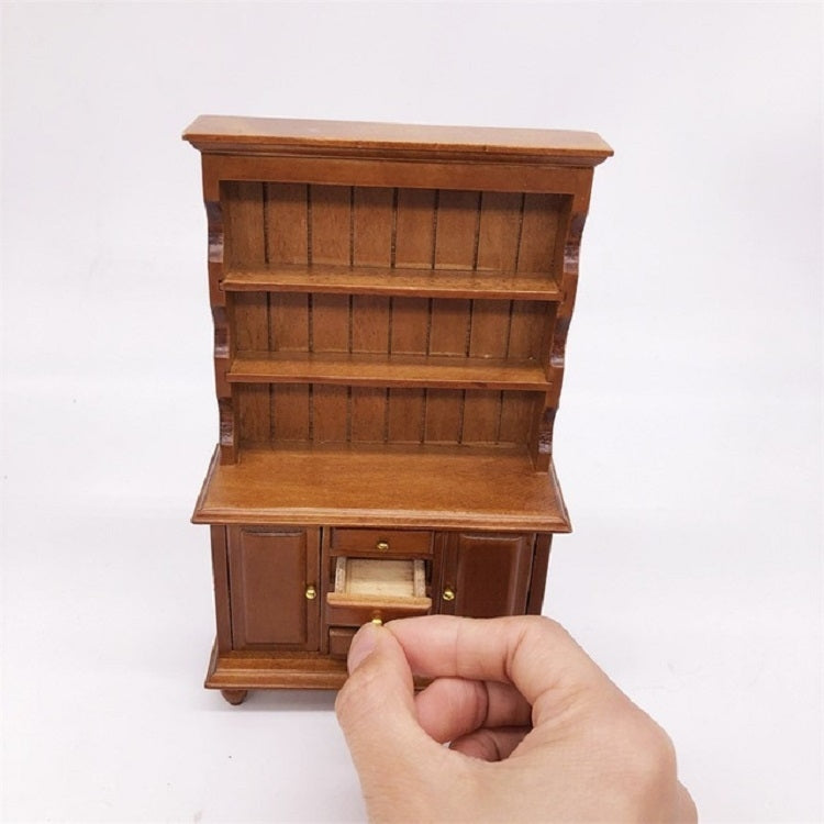Mini dollhouse wooden cabinet bookcase with shelves and front drawers, shown being held