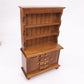Brown miniature cabinet bookcase with side doors, open shelves, and drawer details