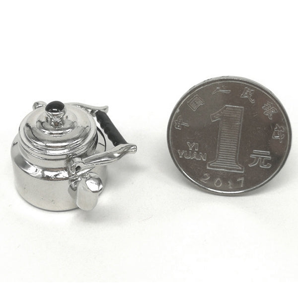Miniature metal tea kettle with black knob lid, silver spout and small side handles.