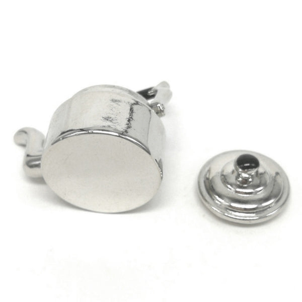 Miniature metal tea kettle with detached black-knob lid, silver spout and side handles.