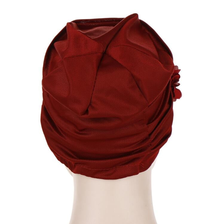 Burgundy linen turban hat wrap with soft gathered folds, flower accents not visible