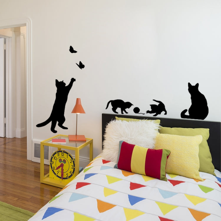 Cat wall sticker silhouettes with butterflies on wall near bed and furniture