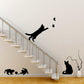 Cat wall sticker silhouettes on stairway wall with butterflies in the space