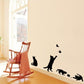 Black cat wall sticker with butterflies along wall beside chair and cushion