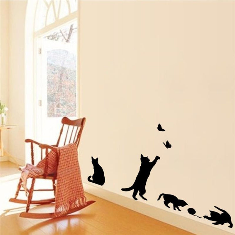 Black cat wall sticker with butterflies along wall beside chair and cushion