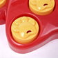 Close-up of red paw slow feeder bowl with yellow bear-face treat block