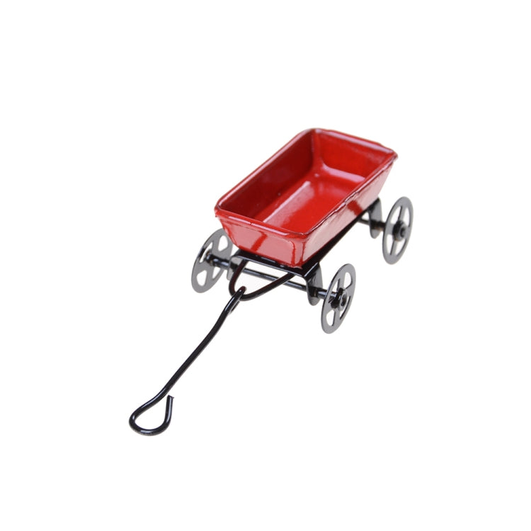Mini red metal garden cart with black wheels and curved pull handle