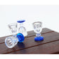 Mini transparent goblet glasses with blue bases, dollhouse table layout