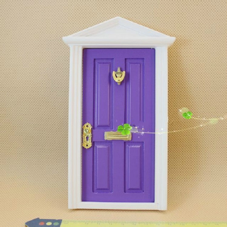 Miniature fairy tale door, purple with gold handle and latch, white frame