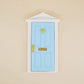 Miniature fairy tale door, sky blue with gold handle and latch, white frame