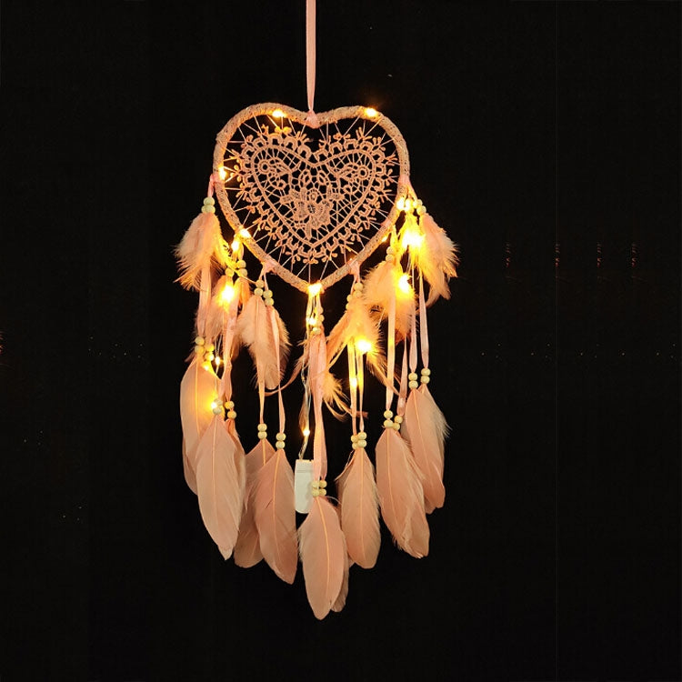 Beige heart dream catcher hanging ornament with warm string lights and long feather strands